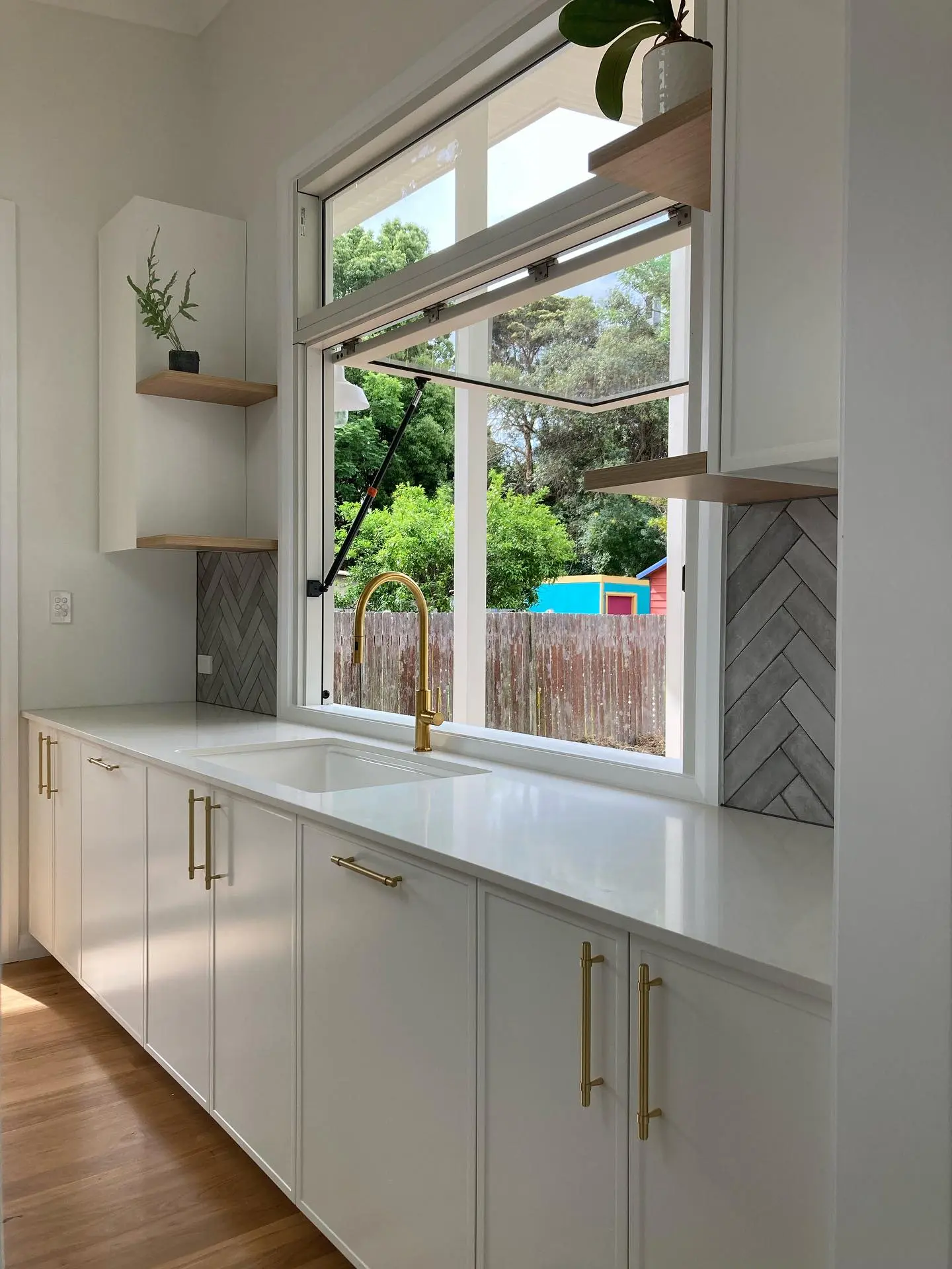 Kitchen renovation with timber floors and stone benchtop